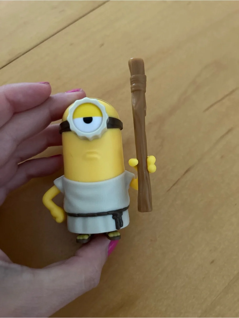 One-Eyed Yellow Action Figure with Brown Staff - Classic Cartoon Style